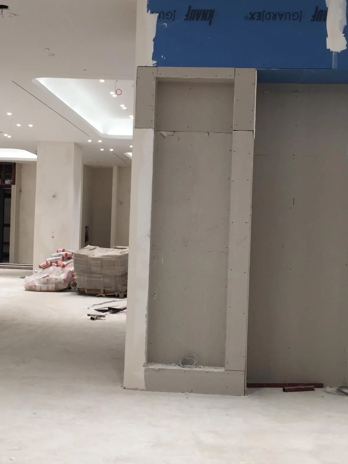 Column cladding in progress in a protected interior