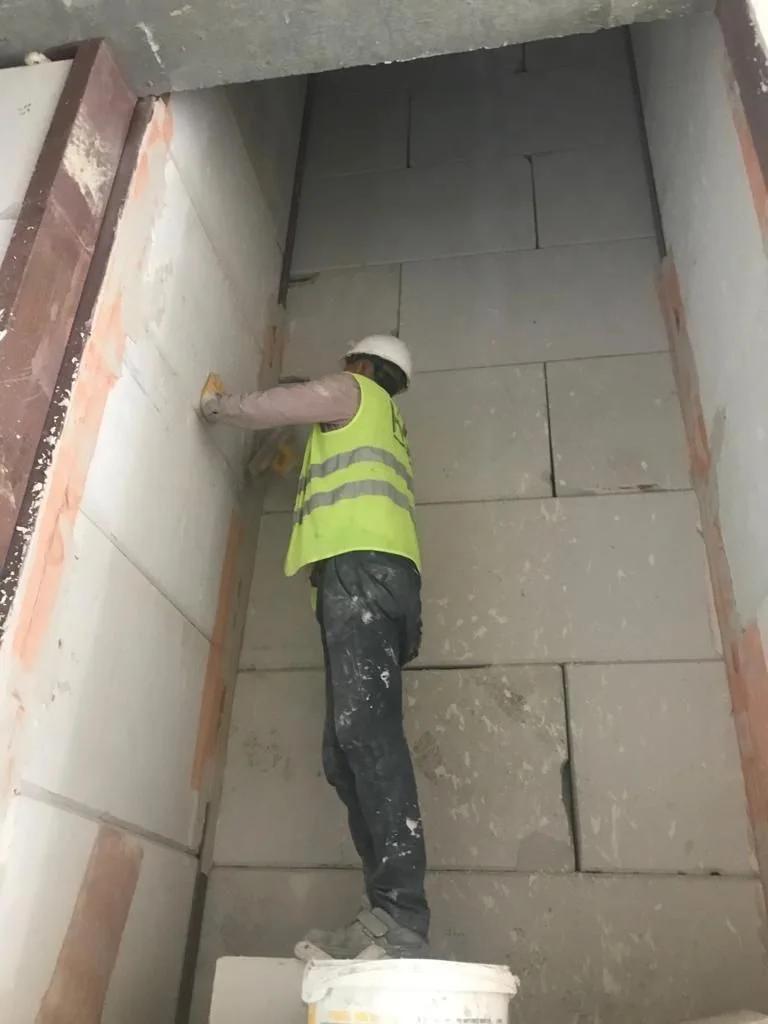 Worker on a stone surface in a narrow void